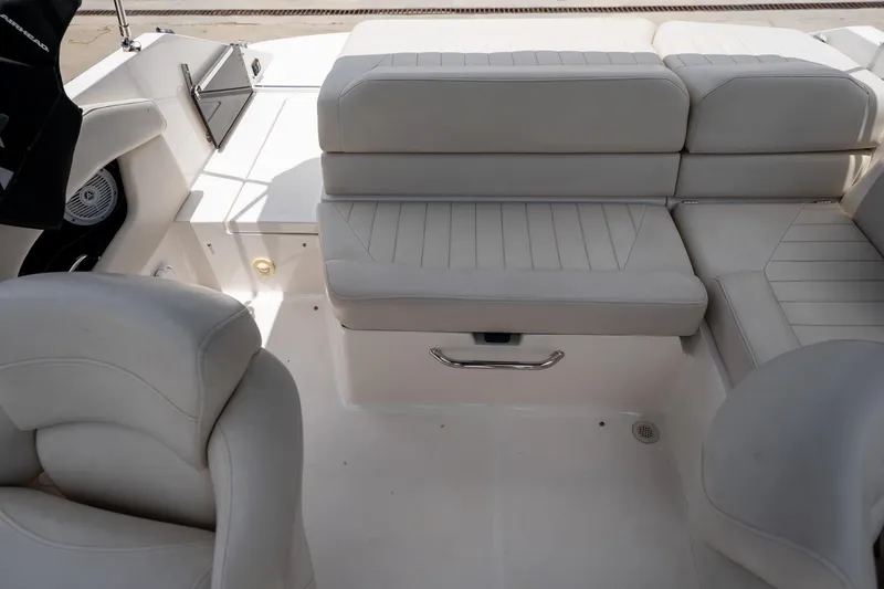 Slide: The Image of Interior seating of a 2008 Regal 2000 Bowrider boat, featuring white cushioned seats. - 24
