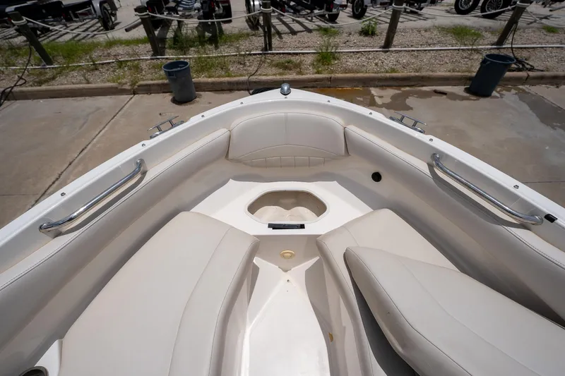 Slide: The Image of 2008 Regal 2000 Bowrider boat interior with white seating and stainless steel handrails. - 26