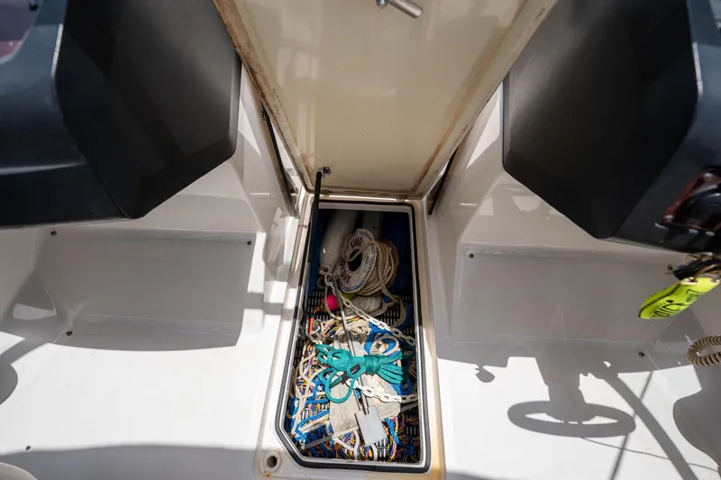 Slide: The Image of Storage compartment of a 2008 Regal 2000 Bowrider boat with ropes and equipment. - 29