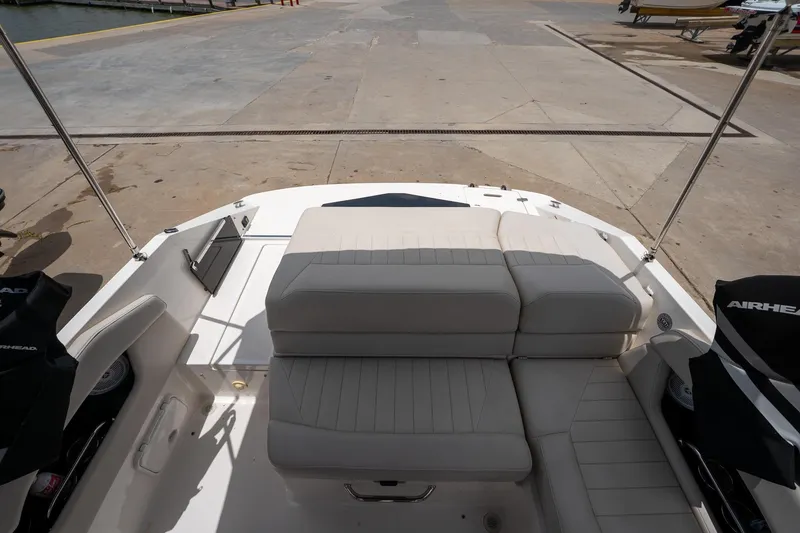 Slide: The Image of 2008 Regal 2000 Bowrider boat interior with beige seating at a dock. - 19