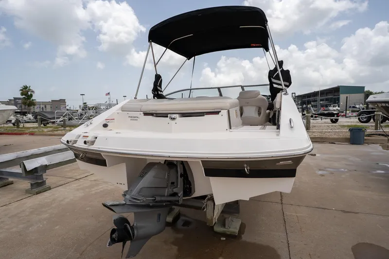 Slide: The Image of 2008 Regal 2000 Bowrider boat with canopy, docked on a sunny day. - 4