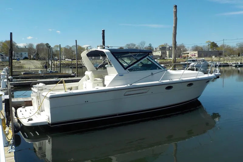 The Image of 2001 Tiara Yachts 3100 Open docked in a serene marina setting. - 0
