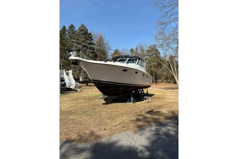 Slide: The Image of 2001 Tiara Yachts 3100 Open boat on land, surrounded by trees. - 31