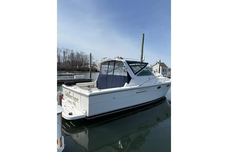 Slide: The Image of 2001 Tiara Yachts 3100 Open boat docked in a serene marina setting. - 30