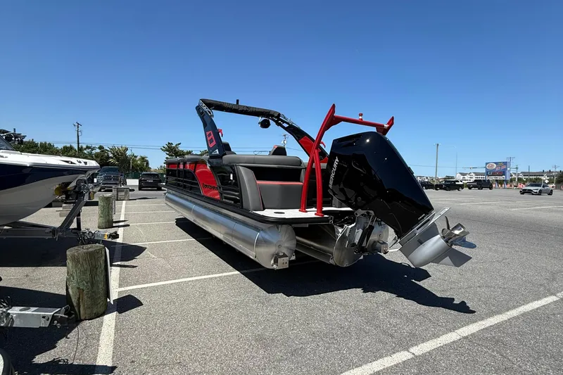 Slide: The Image of 2026 Berkshire 23RFX STS pontoon boat with Mercury outboard in a parking lot. - 6