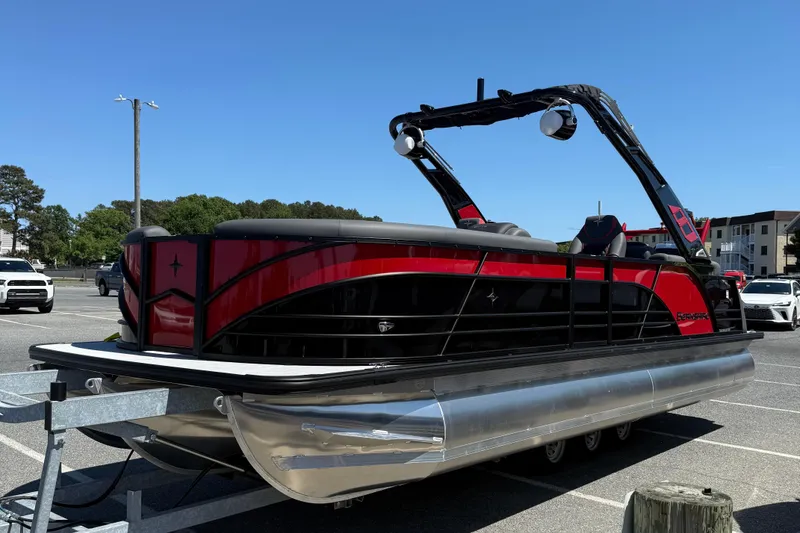 Slide: The Image of 2026 Berkshire 23RFX STS pontoon boat in a parking lot, featuring sleek red and black design. - 4