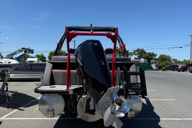 Slide: The Image of 2026 Berkshire 23RFX STS pontoon boat with powerful outboard motor in a parking lot. - 7