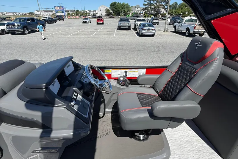 Slide: The Image of 2026 Berkshire 23RFX STS boat interior with sleek steering and luxurious seating. - 12