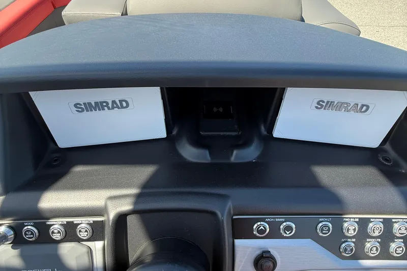 Slide: The Image of Dashboard of 2026 Berkshire 23RFX STS with dual Simrad displays and control panel. - 13