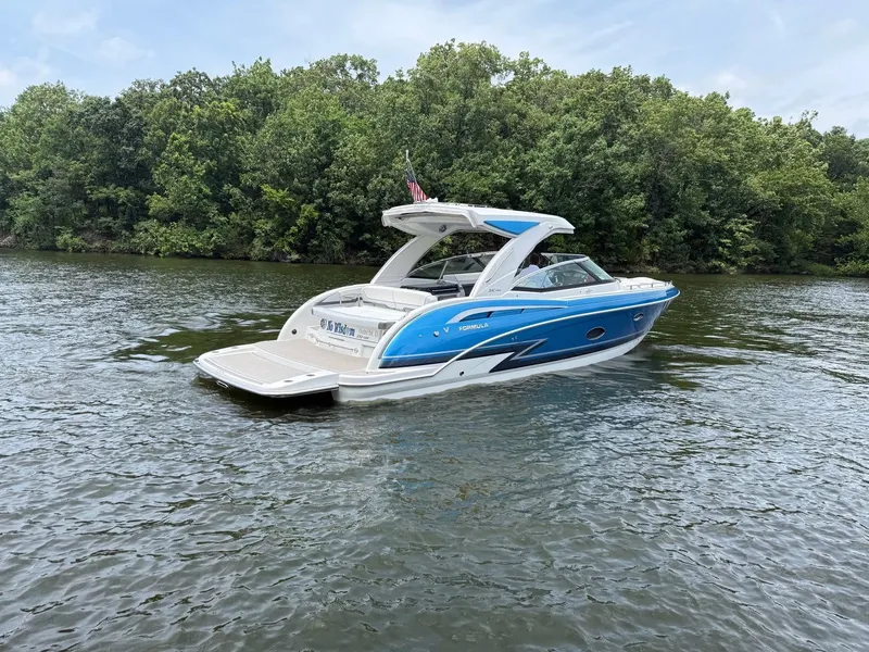 Slide: The Image of A blue and white bowrider boat on a calm river, surrounded by lush greenery. - 5