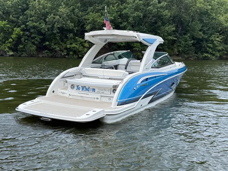 Slide: The Image of A blue and white 2019 Formula 350 Crossover Bowrider on a calm river. - 4