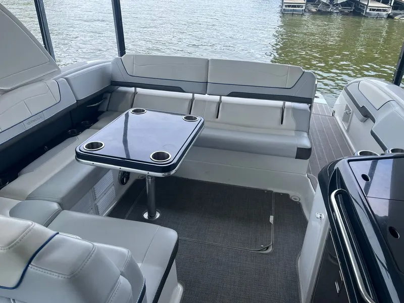 Slide: The Image of The image shows the cockpit of a 2019 Formula 350 Crossover Bowrider with gray seating and a table. - 19