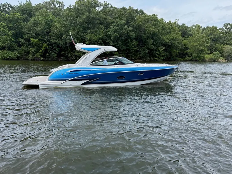 Slide: The Image of A blue and white bowrider boat glides on a calm river, surrounded by lush greenery. - 6