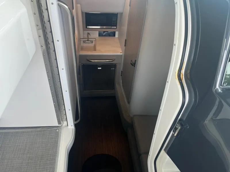 Slide: The Image of Interior of a 2019 Formula 350 Crossover Bowrider with a small kitchenette and seating area. - 11