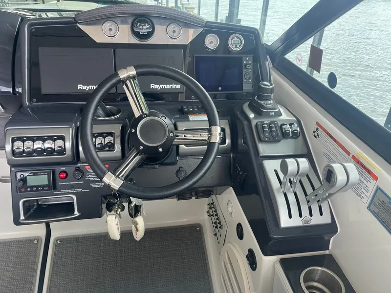 Slide: The Image of The image shows a boat's helm with modern navigation systems and control levers. - 15
