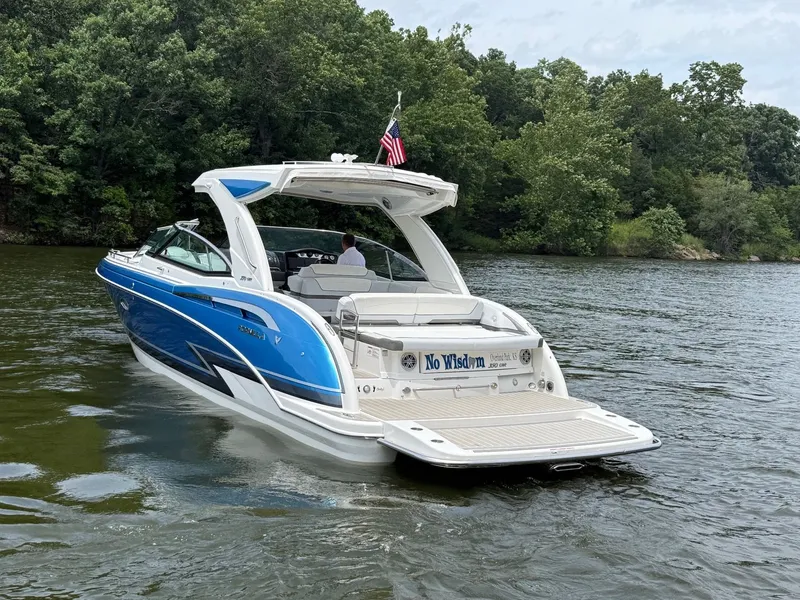 Slide: The Image of A blue and white 2019 Formula 350 Crossover Bowrider cruising on a calm lake. - 2