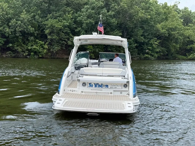 Slide: The Image of A white boat with an open deck cruises on a calm river, surrounded by trees. - 3