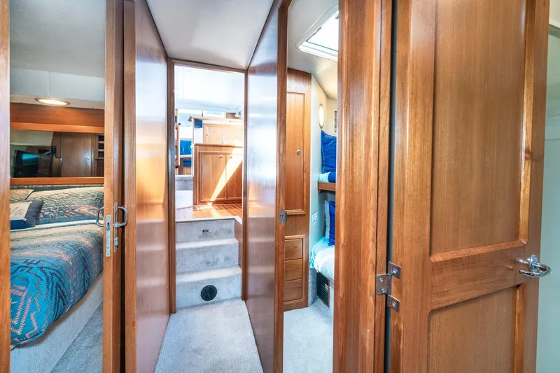 Slide: The Image of Interior of 1999 Riviera 48 Convertible yacht with wooden doors and cozy bedrooms. - 41