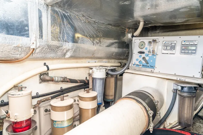 Slide: The Image of Engine room of 1999 Riviera 48 Convertible with filtration system and control panel. - 73