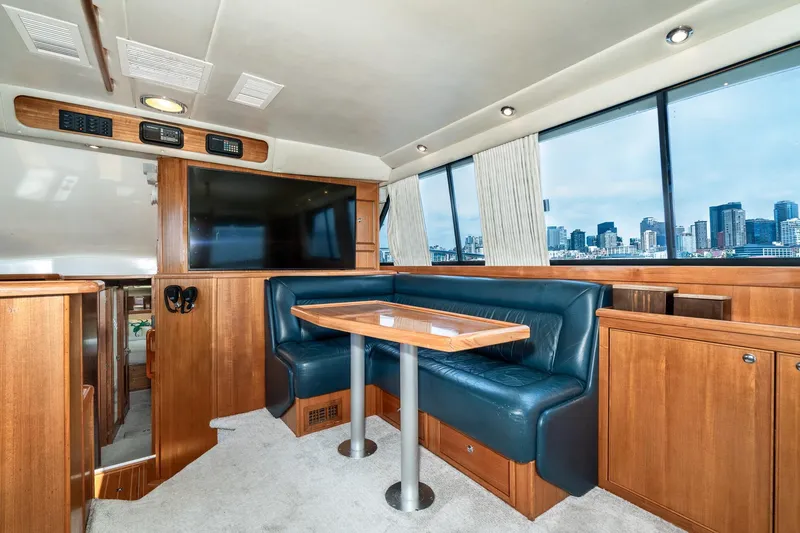 Slide: The Image of Luxurious interior of 1999 Riviera 48 Convertible yacht with city skyline view. - 33