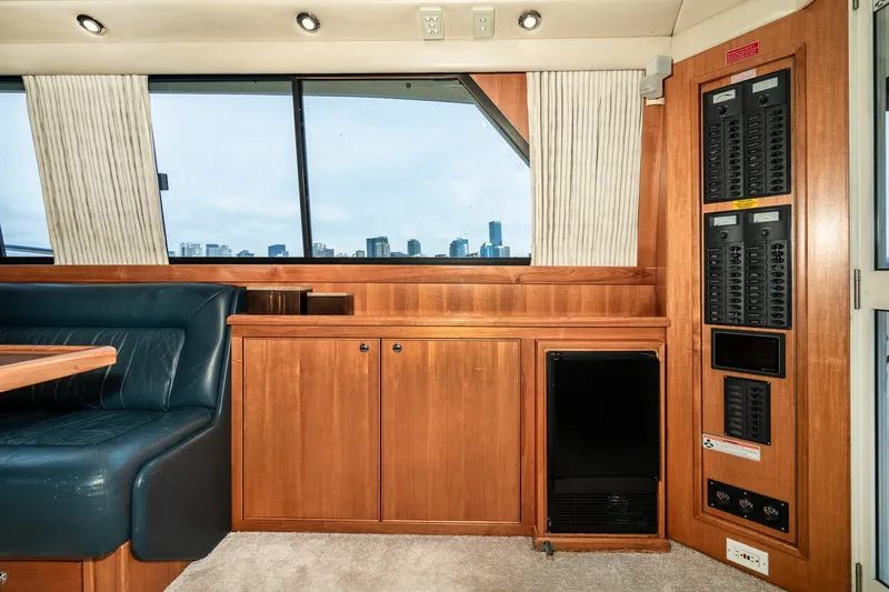 Slide: The Image of Interior of 1999 Riviera 48 Convertible yacht with wood cabinetry and city skyline view. - 35