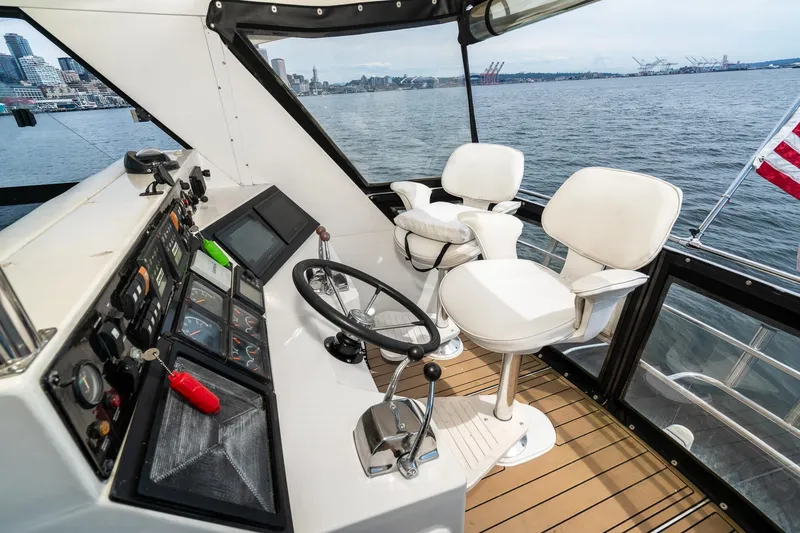Slide: The Image of Cockpit of 1999 Riviera 48 Convertible yacht with steering wheel and control panel. - 12
