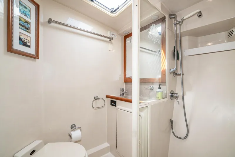 Slide: The Image of Bathroom interior of 1999 Riviera 48 Convertible yacht, featuring shower and sink. - 49