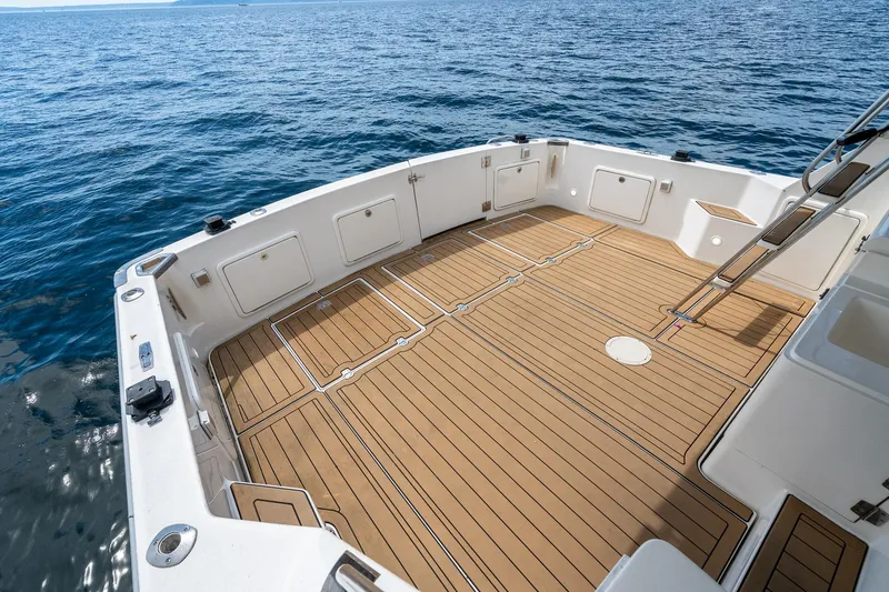 Slide: The Image of Spacious deck of 1999 Riviera 48 Convertible yacht on open water. - 21