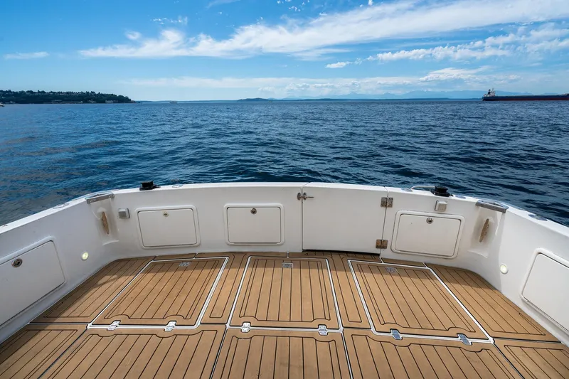 Slide: The Image of 1999 Riviera 48 Convertible yacht deck overlooking serene ocean and blue sky. - 22