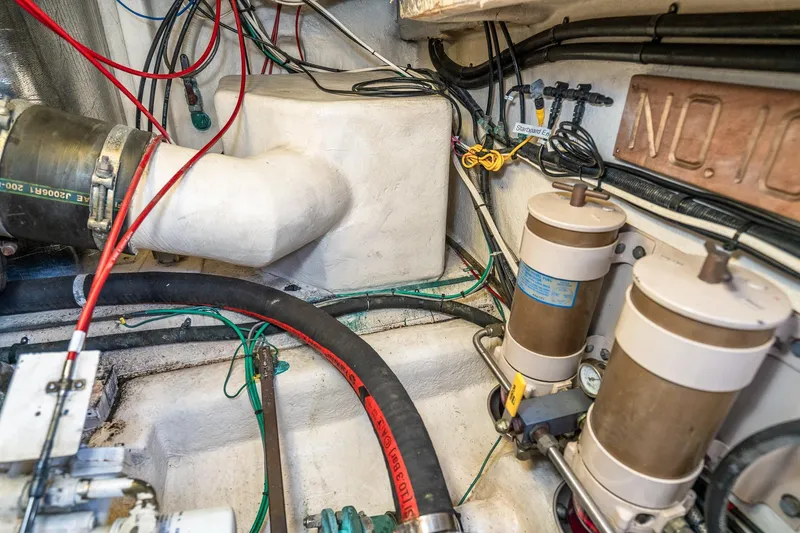 Slide: The Image of Engine room of 1999 Riviera 48 Convertible with wiring and filtration systems. - 69