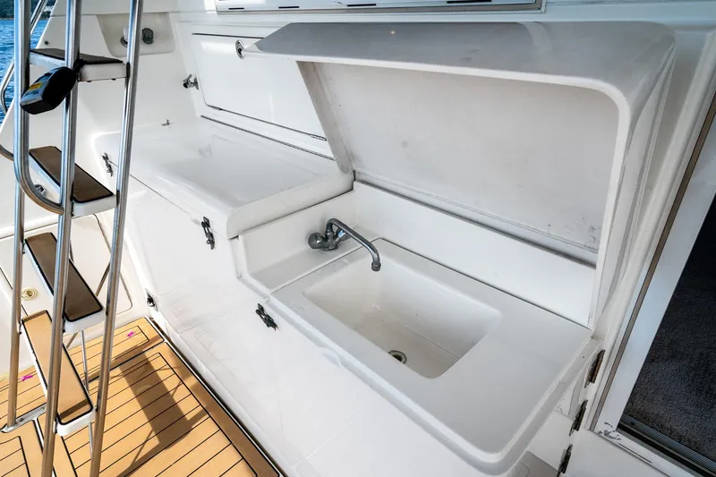 Slide: The Image of Outdoor sink area on 1999 Riviera 48 Convertible yacht deck. - 27
