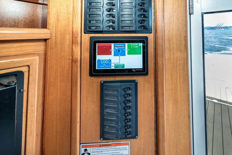 Slide: The Image of Control panel on 1999 Riviera 48 Convertible yacht with digital display and switches. - 36
