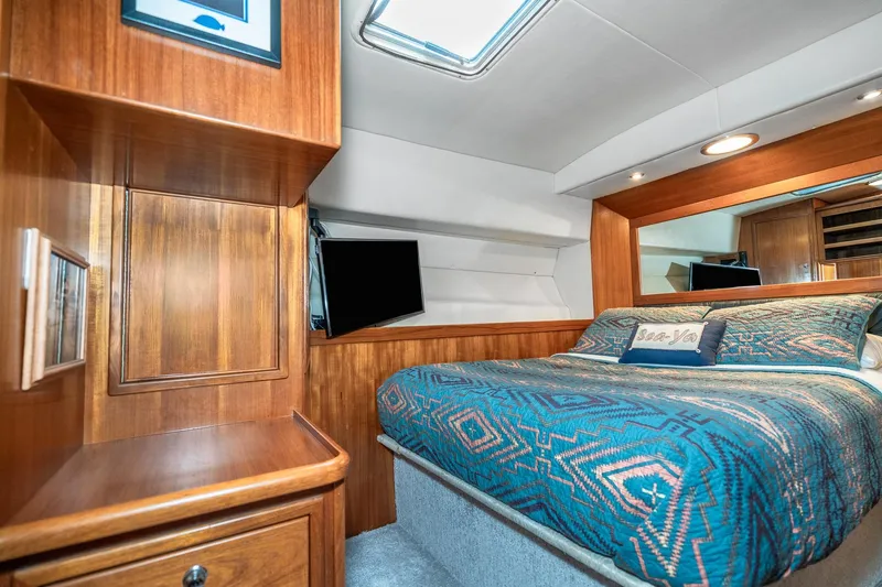 Slide: The Image of Luxurious cabin interior of 1999 Riviera 48 Convertible yacht with cozy bedding. - 47