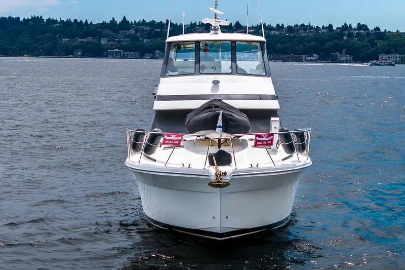 Slide: The Image of 1999 Riviera 48 Convertible yacht on open water, front view. - 56
