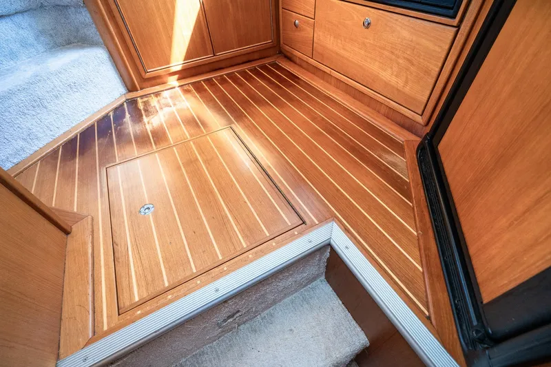 Slide: The Image of Polished wooden flooring inside a 1999 Riviera 48 Convertible yacht cabin. - 40