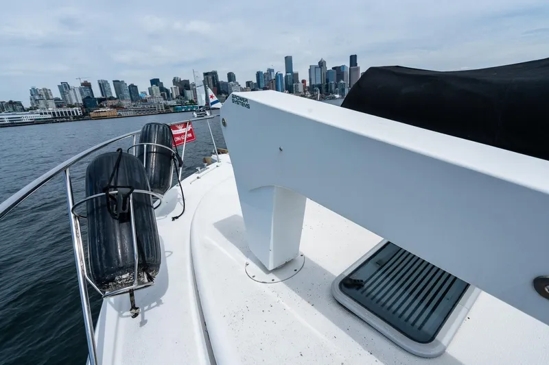 Slide: The Image of 1999 Riviera 48 Convertible yacht with city skyline in the background. - 62