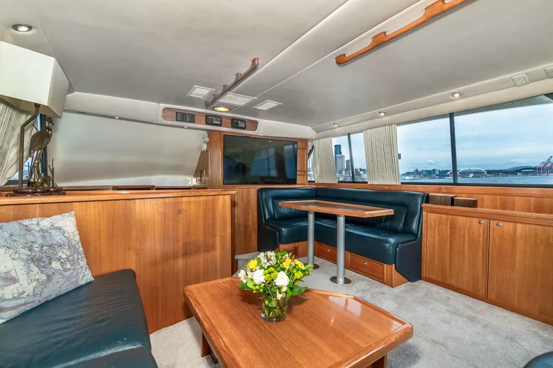 Slide: The Image of Luxurious interior of 1999 Riviera 48 Convertible yacht with elegant wood finishes and scenic views. - 31