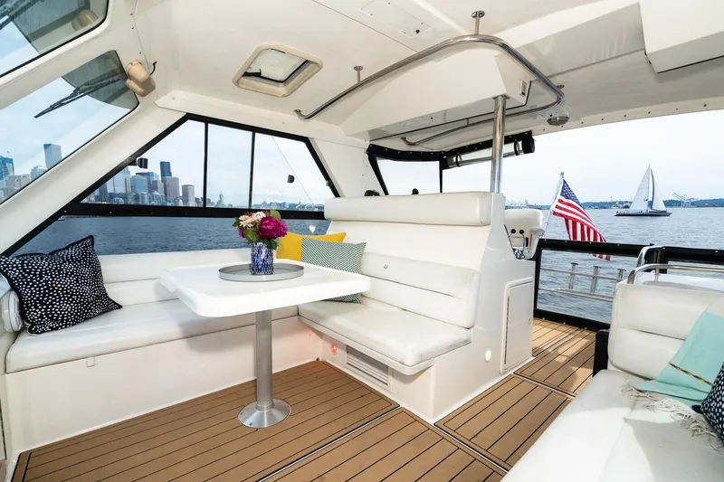 Slide: The Image of Luxurious interior of 1999 Riviera 48 Convertible yacht with city skyline view. - 17