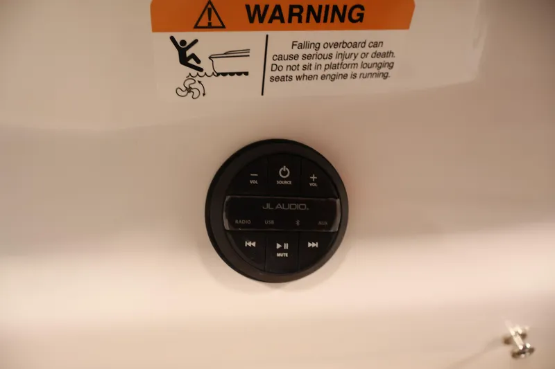 Slide: The Image of 2026 Four Winns H4 boat audio controls with safety warning label above. - 48