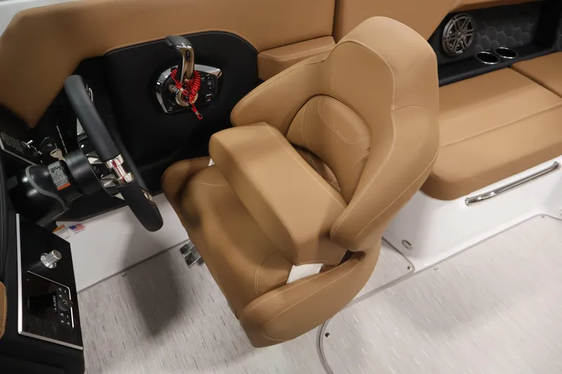 Slide: The Image of 2026 Four Winns H4 boat interior with tan seating and steering wheel. - 26