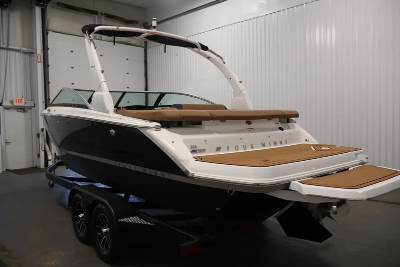 Slide: The Image of 2026 Four Winns H4 boat in a garage, showcasing sleek design and modern features. - 6