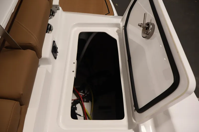 Slide: The Image of Open storage compartment on 2026 Four Winns H4 boat with brown seating. - 42