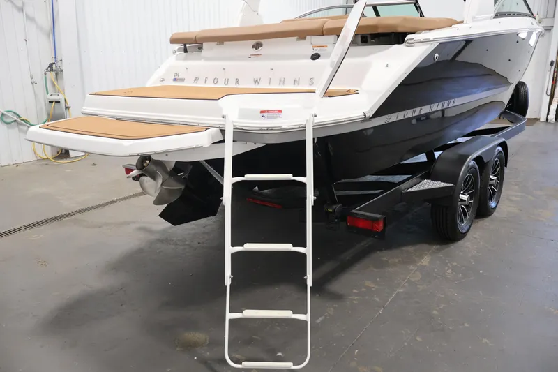 Slide: The Image of 2026 Four Winns H4 boat on trailer with swim platform and ladder in garage. - 50