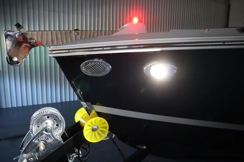 Slide: The Image of 2026 Four Winns H4 boat with trailer, illuminated in a storage facility. - 60