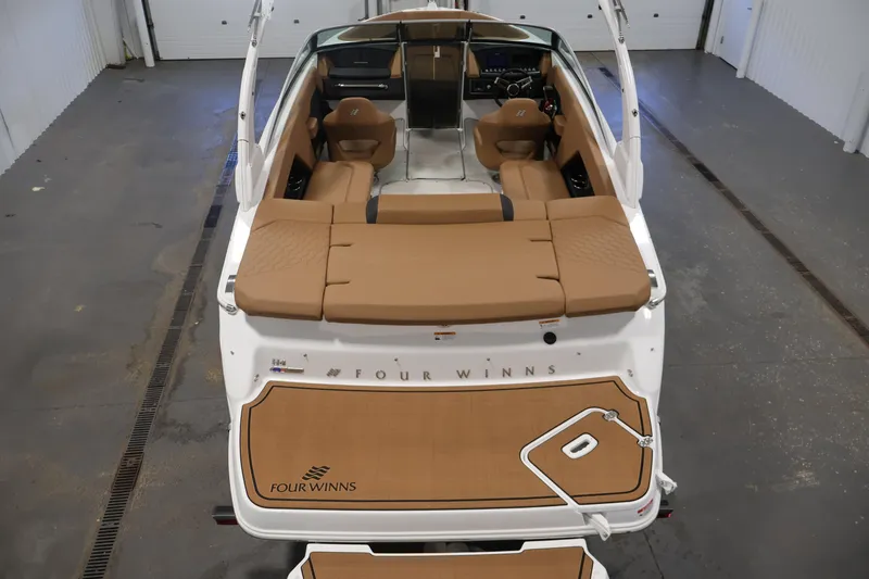 Slide: The Image of 2026 Four Winns H4 boat interior with tan seating and sleek design. - 9