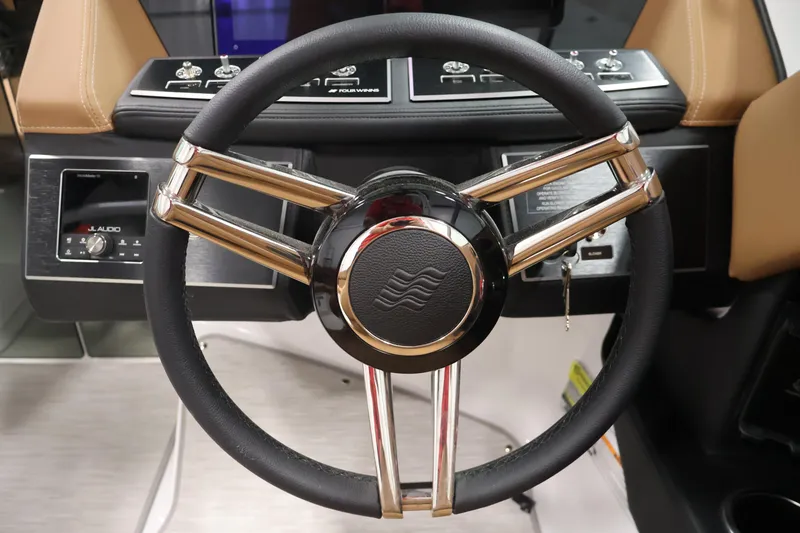 Slide: The Image of Steering wheel of 2026 Four Winns H4 boat with modern dashboard controls. - 18