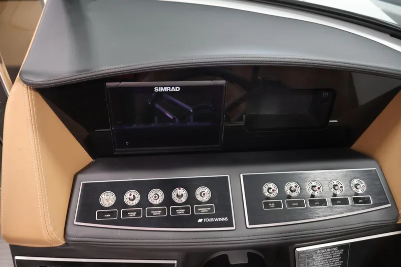 Slide: The Image of Dashboard of 2026 Four Winns H4 boat with Simrad display and control panel. - 19