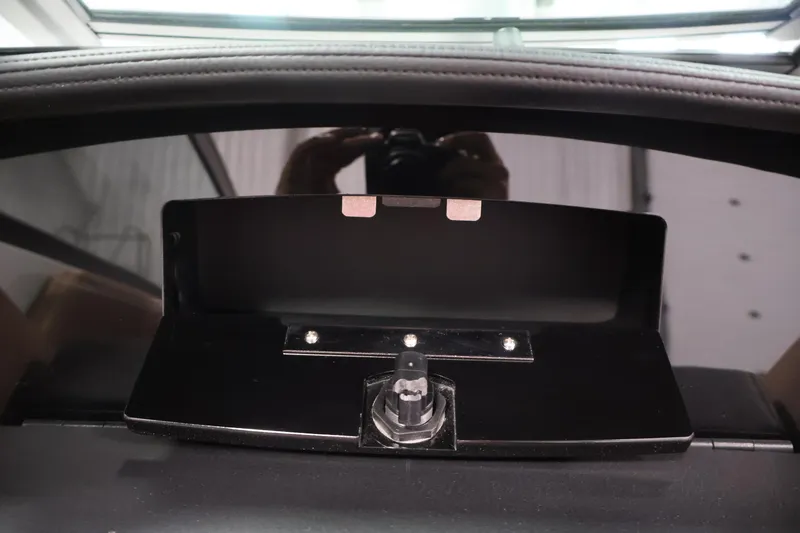 Slide: The Image of 2026 Four Winns H4 dashboard compartment with latch, interior view. - 28