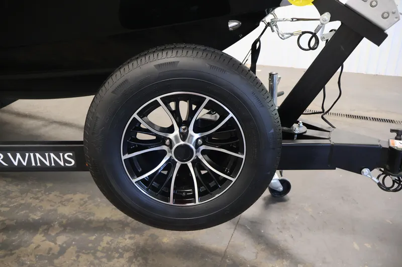 Slide: The Image of 2026 Four Winns H4 trailer wheel with sleek black alloy rim design. - 54