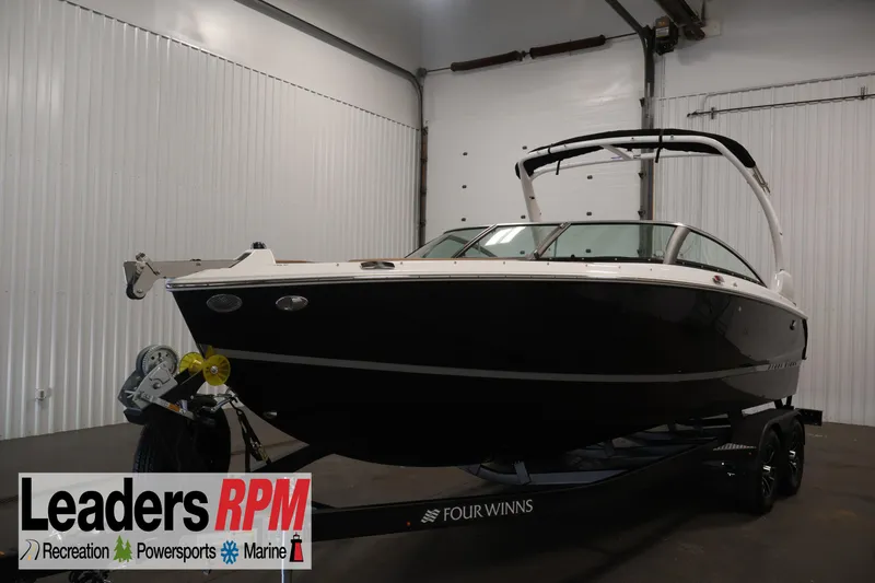The Image of 2026 Four Winns H4 boat in showroom, displayed on trailer. - 0